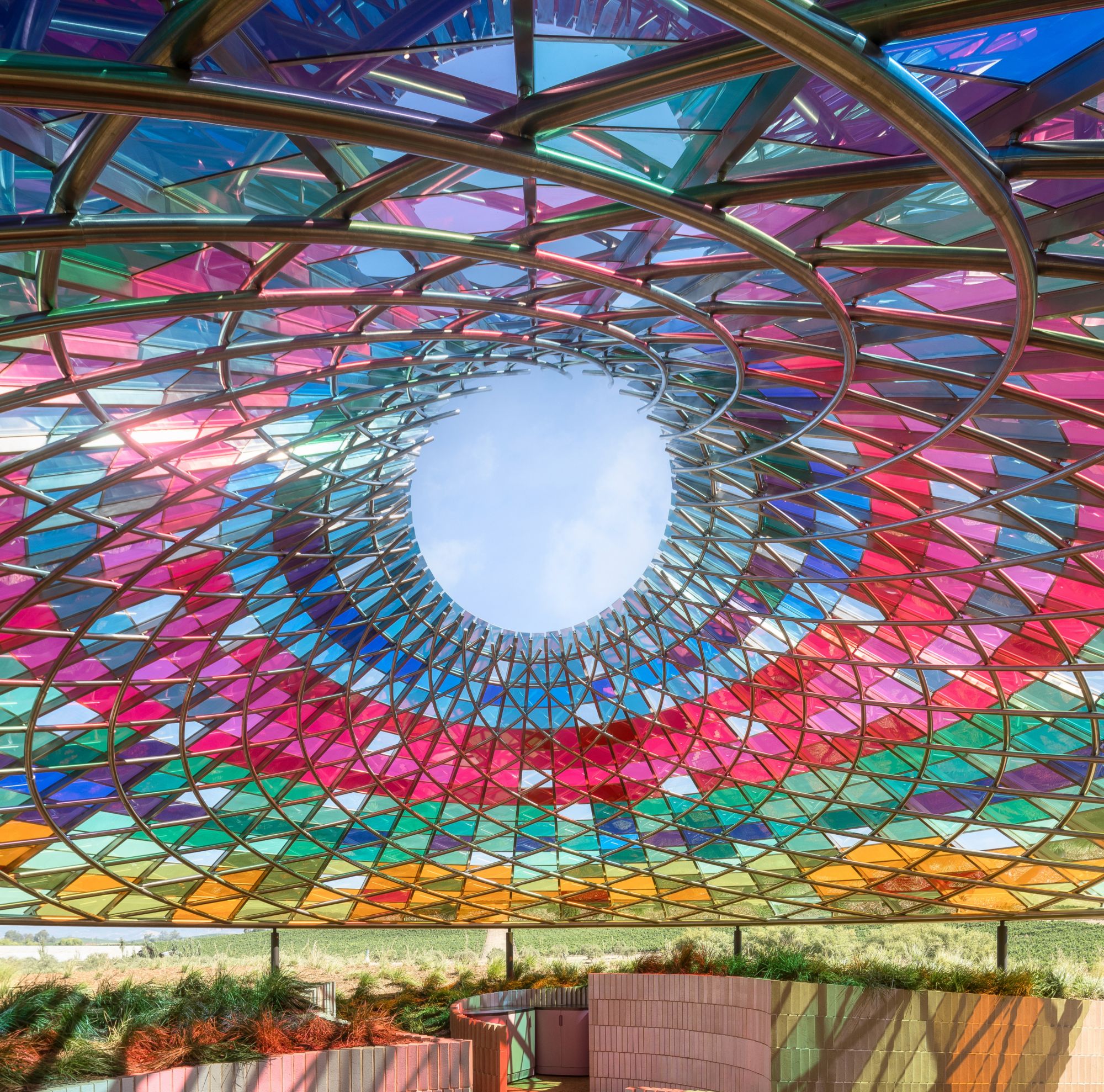 Vertical Panorama Pavillion features 832 laminated glass panels with 24 variations of transparent hues using Vanceva color PVB interlayers 